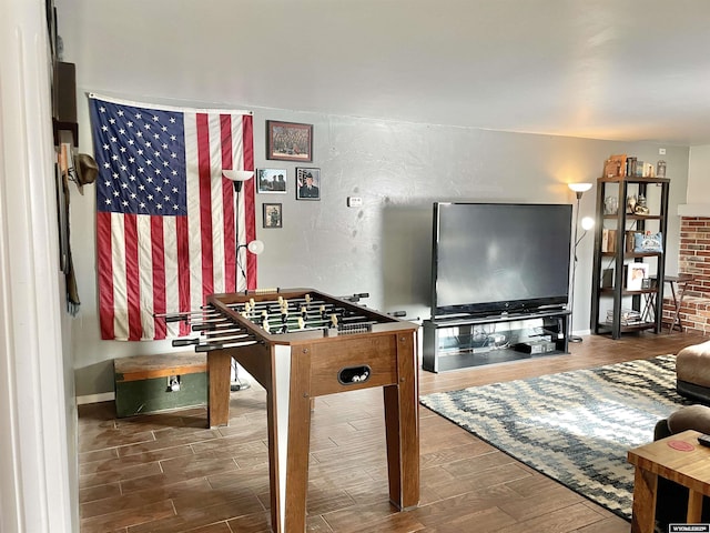 recreation room with dark hardwood / wood-style flooring