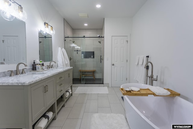 bathroom featuring vanity, tile patterned flooring, and shower with separate bathtub