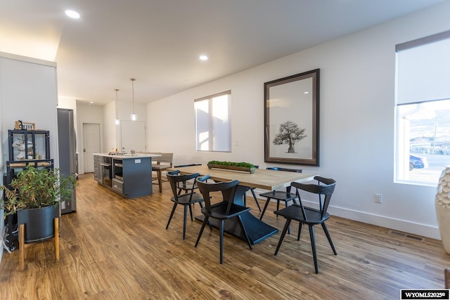 dining space featuring dark wood-type flooring