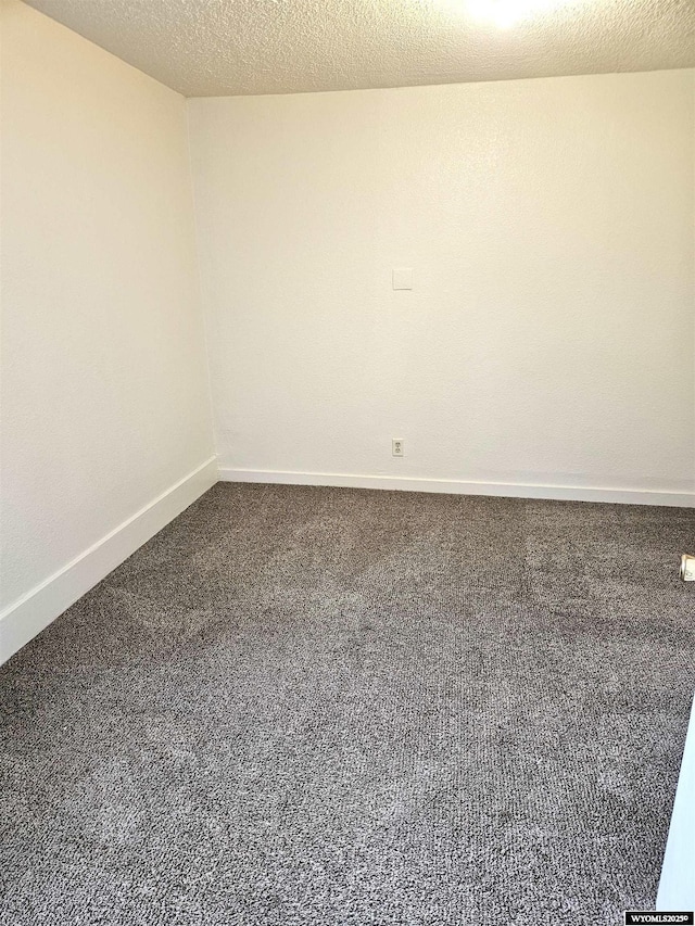 carpeted spare room with a textured ceiling