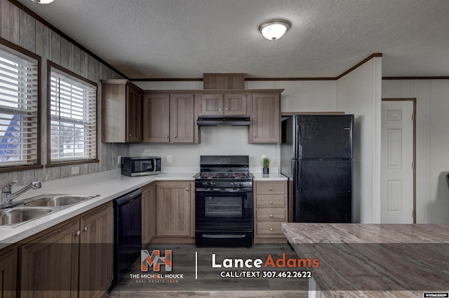 kitchen with crown molding, sink, a textured ceiling, and black appliances