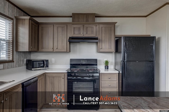kitchen featuring ornamental molding, a textured ceiling, and black appliances