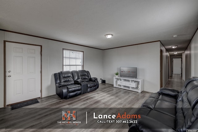 living room featuring crown molding and hardwood / wood-style flooring