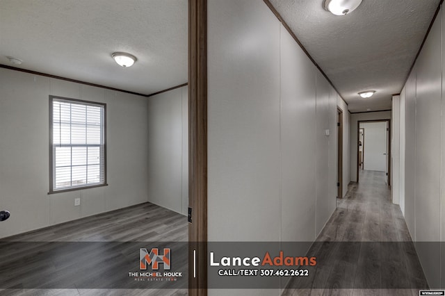 hall with crown molding, wood-type flooring, and a textured ceiling