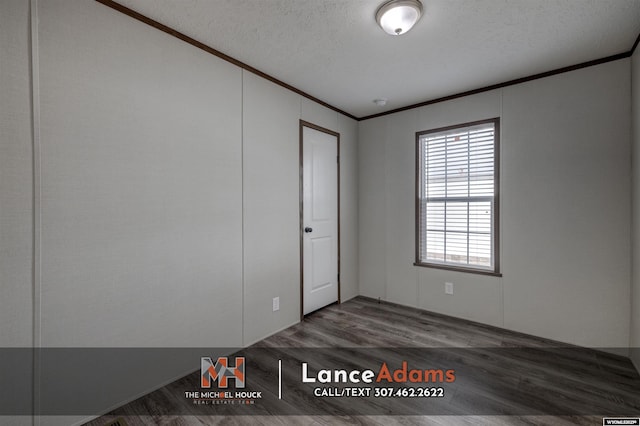 empty room featuring crown molding, dark hardwood / wood-style floors, and a textured ceiling