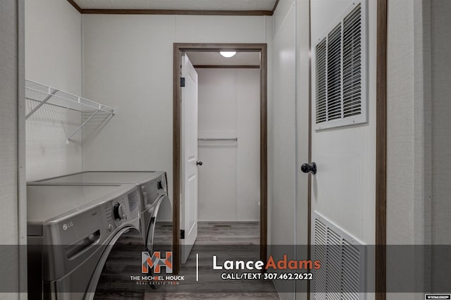 laundry room featuring washing machine and dryer and hardwood / wood-style floors