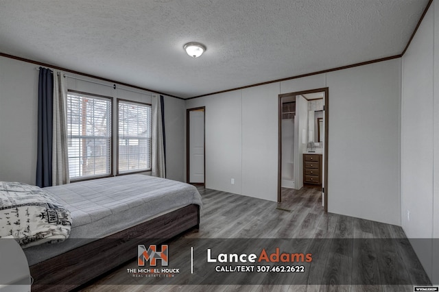 bedroom with hardwood / wood-style flooring, crown molding, and a textured ceiling