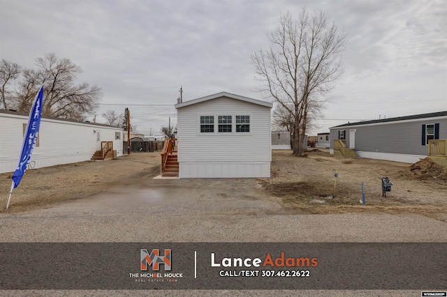view of front of property featuring a garage and an outdoor structure