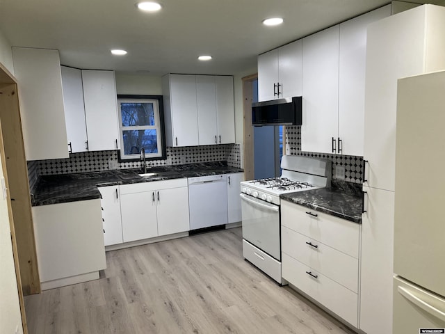 kitchen with sink, white appliances, white cabinetry, backsplash, and light hardwood / wood-style floors