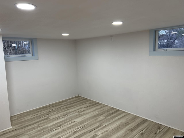 basement with light hardwood / wood-style flooring