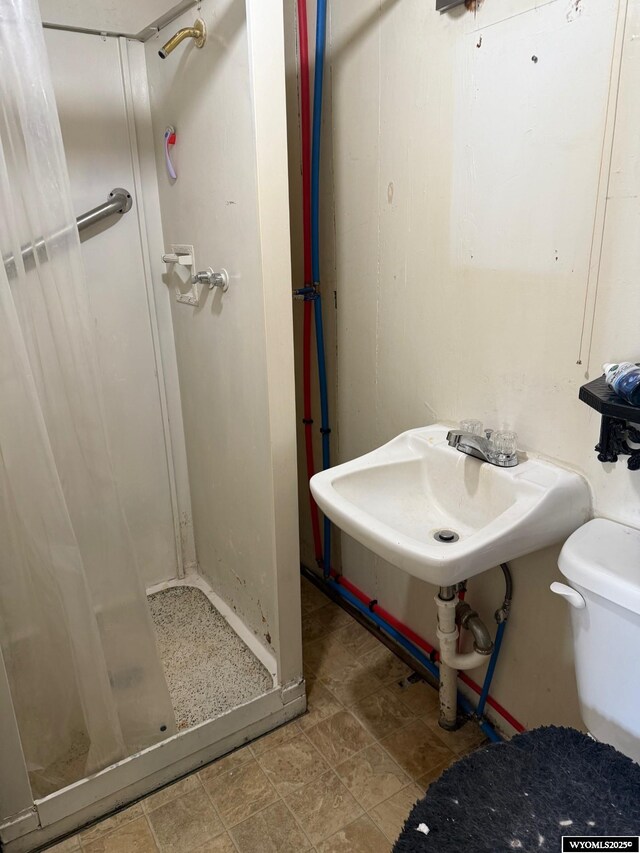 bathroom with walk in shower and toilet