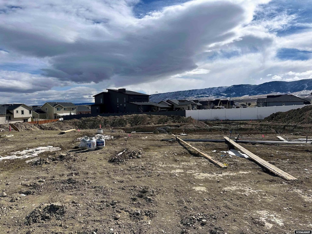 view of yard featuring fence and a mountain view