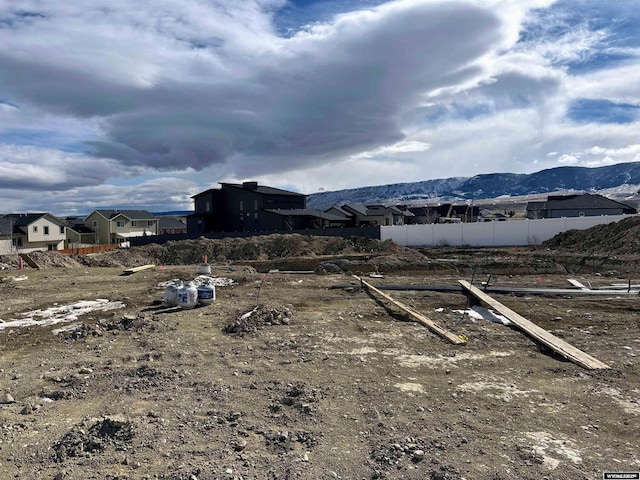 view of yard featuring fence and a mountain view