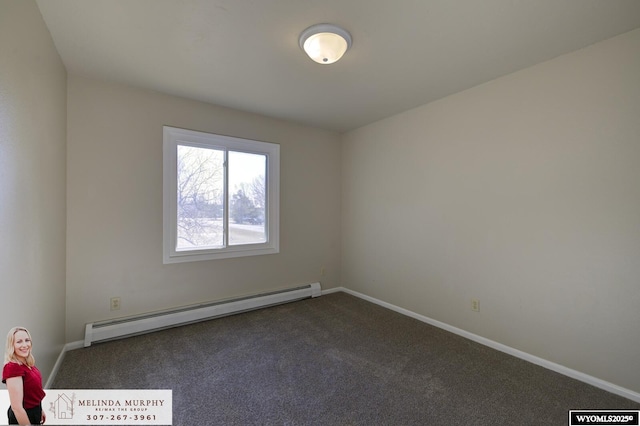 empty room featuring baseboards, a baseboard heating unit, and dark carpet