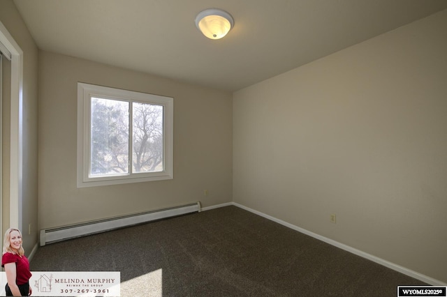 carpeted empty room with baseboard heating and baseboards