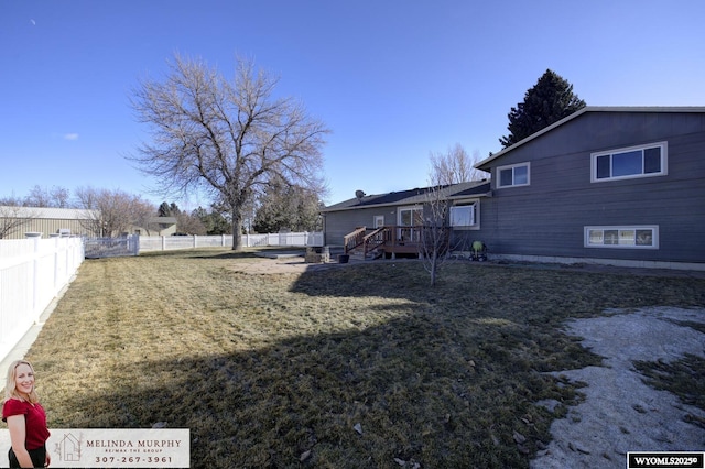 exterior space featuring a fenced backyard and a wooden deck