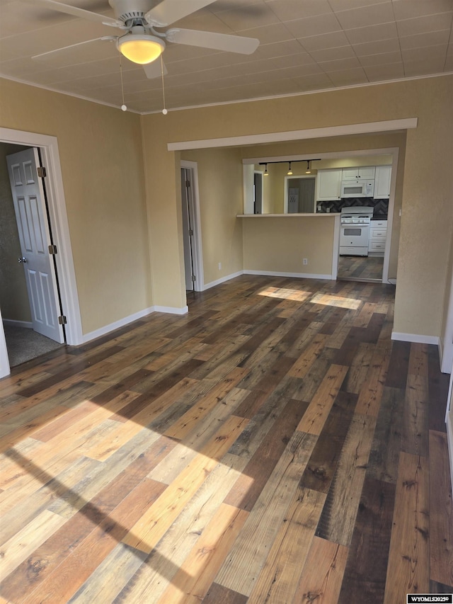 unfurnished living room with ceiling fan and dark hardwood / wood-style flooring