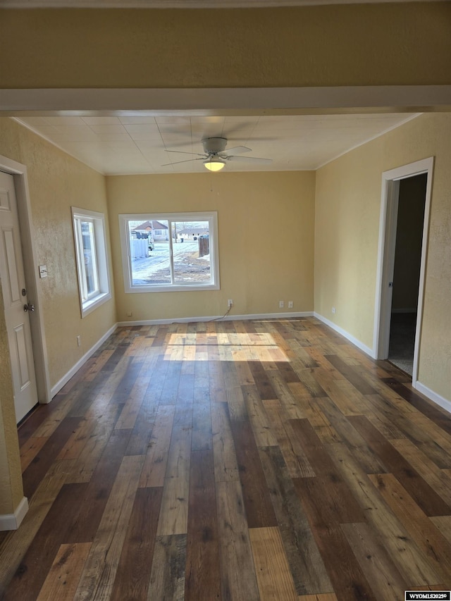 spare room featuring dark hardwood / wood-style floors and ceiling fan