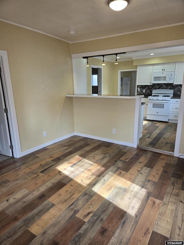 interior space with dark hardwood / wood-style flooring and ornamental molding