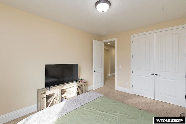 carpeted bedroom with a closet