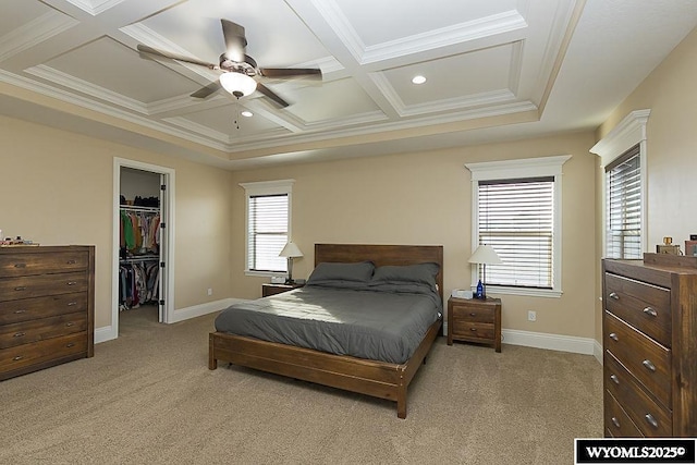 carpeted bedroom with coffered ceiling, a spacious closet, beam ceiling, and crown molding