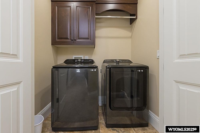 laundry room with cabinets and washing machine and clothes dryer