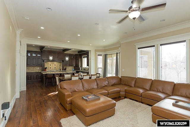 living room featuring crown molding, ceiling fan, and dark hardwood / wood-style floors