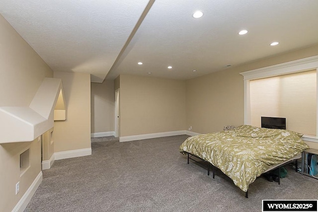 bedroom featuring carpet floors and a textured ceiling