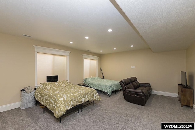 bedroom with carpet floors and a textured ceiling