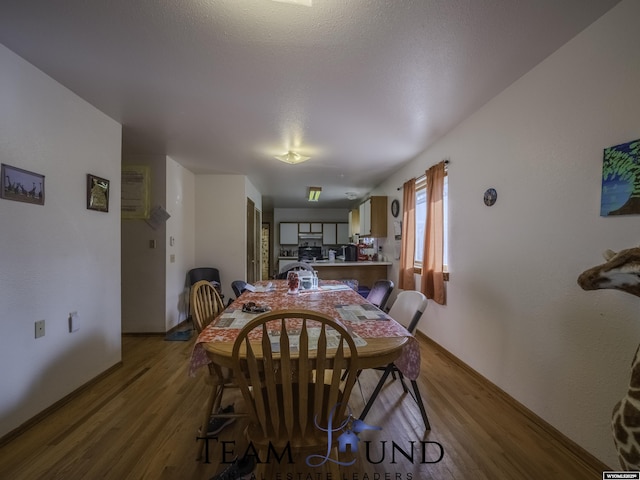 dining space featuring wood-type flooring