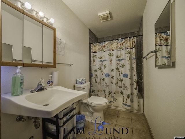 full bathroom with shower / bathtub combination with curtain, sink, a textured ceiling, tile patterned floors, and toilet