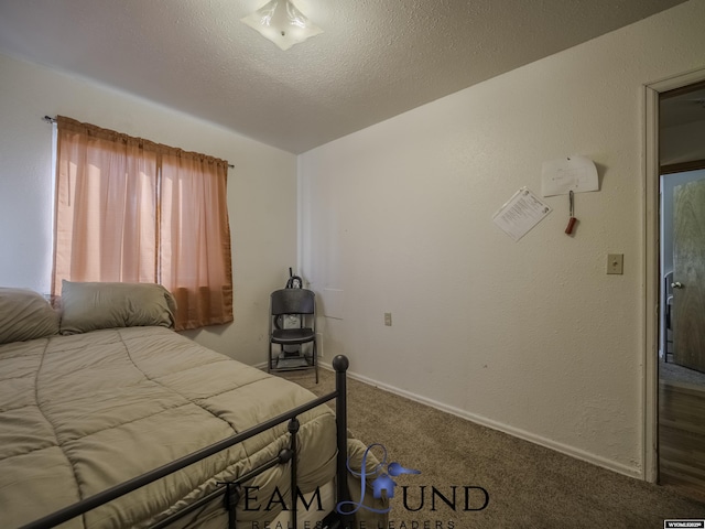 unfurnished bedroom with carpet and a textured ceiling