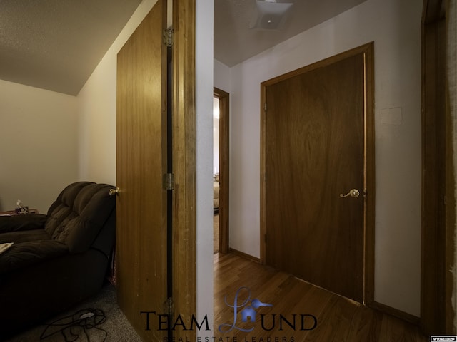 corridor with light hardwood / wood-style floors