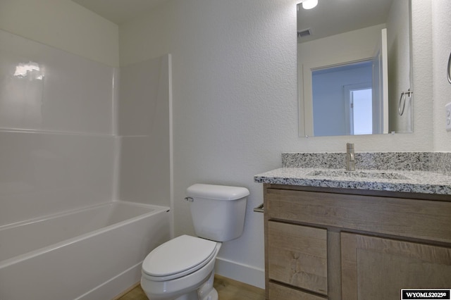 full bathroom with vanity, tub / shower combination, and toilet