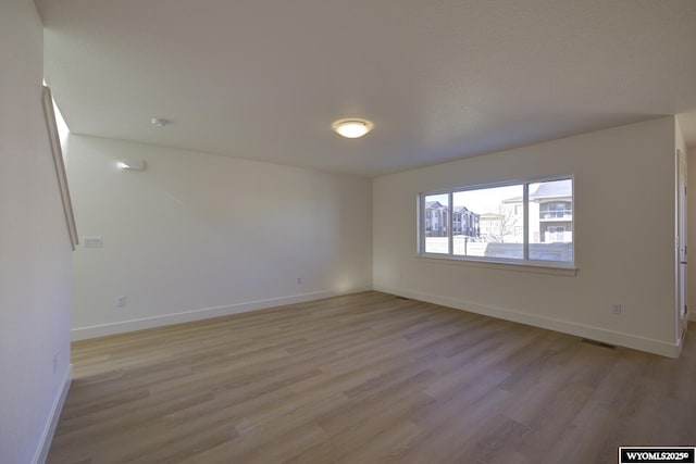 spare room featuring light wood-type flooring