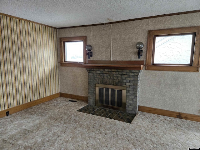 unfurnished living room featuring ornamental molding, a brick fireplace, carpet, and a textured ceiling