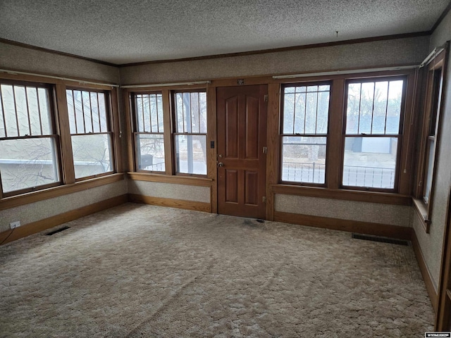 interior space with crown molding and a textured ceiling