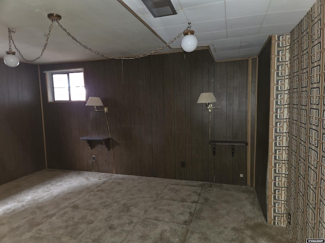 interior space featuring carpet floors and wood walls