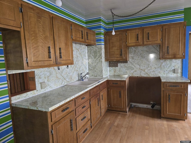 kitchen featuring light hardwood / wood-style floors, sink, and backsplash