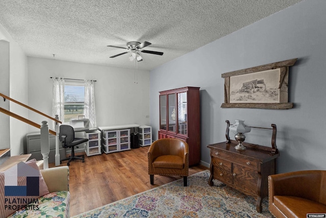 office with hardwood / wood-style floors, a textured ceiling, and ceiling fan