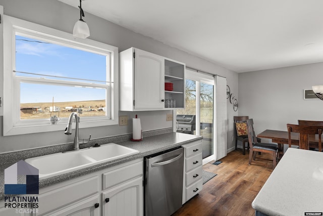 kitchen with pendant lighting, sink, white cabinetry, dark hardwood / wood-style floors, and stainless steel dishwasher