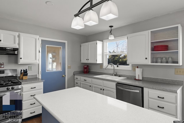 kitchen featuring white cabinetry, stainless steel appliances, decorative light fixtures, and sink