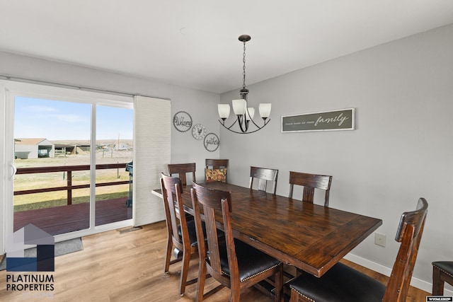 dining room featuring a chandelier and light hardwood / wood-style flooring