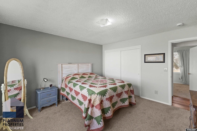 carpeted bedroom featuring a closet and a textured ceiling