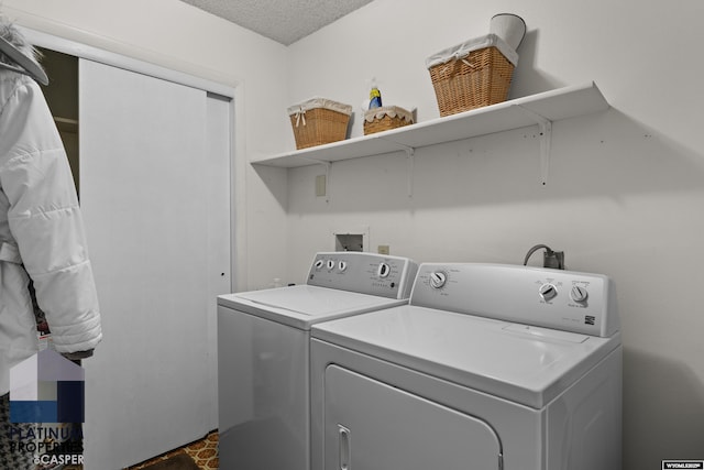 washroom featuring independent washer and dryer and a textured ceiling