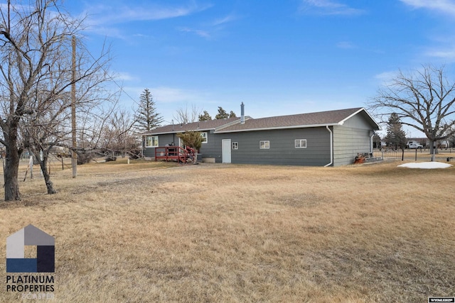 back of property featuring a lawn