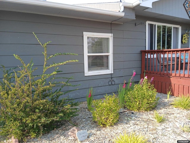 view of property exterior with a deck