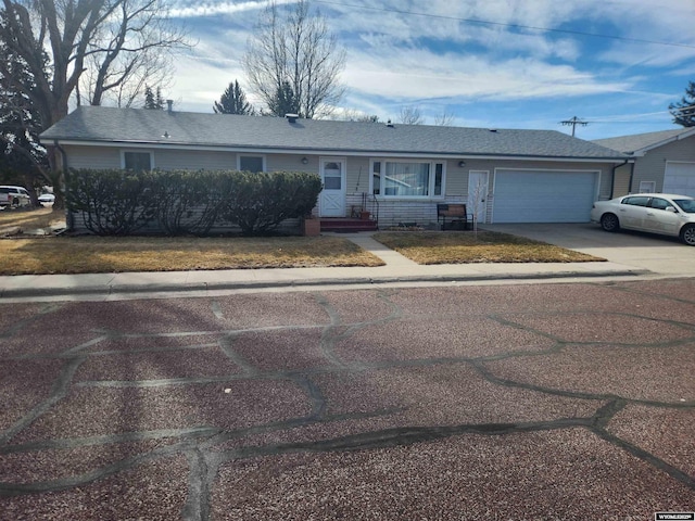 ranch-style home with driveway and an attached garage