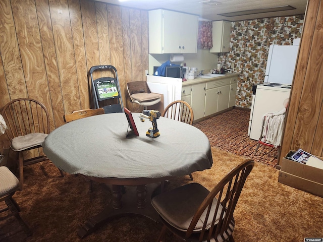 dining area with wood walls and carpet flooring