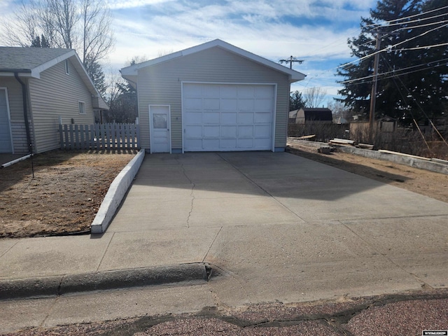 detached garage with driveway and fence